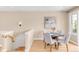 Bright dining area with hardwood floors and a contemporary painting, complemented by a stairway and natural light at 1824 Pearl St # B, Boulder, CO 80302