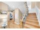 Hallway with hardwood floors, stairs, and doorway to the bedroom creating sense of depth at 1824 Pearl St # B, Boulder, CO 80302