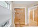 Bright hallway with wood floors and closet featuring bi-fold wood doors and a modern white coat rack at 1824 Pearl St # B, Boulder, CO 80302