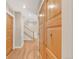 Hallway featuring natural wood floors and a staircase with wood and wrought iron banister and wood doors at 1824 Pearl St # B, Boulder, CO 80302