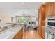 Open kitchen featuring custom cabinets, stainless steel appliances, and a cozy living space at 1824 Pearl St # B, Boulder, CO 80302