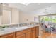 Elegant kitchen with a stylish breakfast bar, hardwood cabinets, and a view of the living area at 1824 Pearl St # B, Boulder, CO 80302