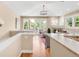 Open concept living space with fireplace, wood floors, chandelier and access to outdoor patio at 1824 Pearl St # B, Boulder, CO 80302
