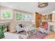 This open-concept living room flows into a modern kitchen, complete with wood floors, a fireplace and plenty of natural light at 1824 Pearl St # B, Boulder, CO 80302