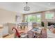 Inviting living room featuring a cozy fireplace, balcony access, and stylish furnishings and a modern light fixture at 1824 Pearl St # B, Boulder, CO 80302