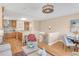 Bright open living room with wood floors flows into the kitchen and breakfast nook, featuring a modern chandelier at 1824 Pearl St # B, Boulder, CO 80302