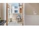 Cozy patio with modern chair and stool viewed through French doors and windows at 1824 Pearl St # B, Boulder, CO 80302