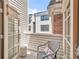 Cozy patio with chair and stool between two French doors and a view of the exterior of neighboring buildings at 1824 Pearl St # B, Boulder, CO 80302