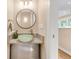 Chic powder room with a vessel sink, modern faucet, and elegant lighting with an opening to another room at 1824 Pearl St # B, Boulder, CO 80302
