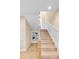 Staircase with light wood treads, white risers and trim, and railing with painted newel posts at 1824 Pearl St # B, Boulder, CO 80302
