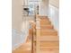 Staircase with light wood treads and metal railing with painted trim and paneled walls at 1824 Pearl St # B, Boulder, CO 80302