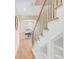 Bright stairway with wooden railing and treads leading to an arched hallway at 1824 Pearl St # B, Boulder, CO 80302