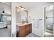 Well-lit bathroom featuring a wooden vanity, updated fixtures, and a walk-in shower at 12945 E Colorado Ave, Aurora, CO 80012