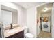 Bathroom featuring a granite countertop, updated fixtures, and convenient washer and dryer at 12945 E Colorado Ave, Aurora, CO 80012
