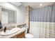Bathroom featuring a tile shower and stone counter at 12945 E Colorado Ave, Aurora, CO 80012
