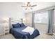 Cozy bedroom with neutral decor, a ceiling fan, and ample natural light at 12945 E Colorado Ave, Aurora, CO 80012