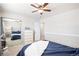 Bedroom with a mirrored closet, ceiling fan, and neutral decor; offering a serene atmosphere at 12945 E Colorado Ave, Aurora, CO 80012