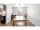 Formal dining room featuring hardwood floors, a modern light fixture, and wainscoting details at 12945 E Colorado Ave, Aurora, CO 80012