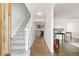 A bright entryway features hardwood floors, carpeted stairs, and an open view to the kitchen at 12945 E Colorado Ave, Aurora, CO 80012