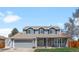 Charming two-story home with a well-manicured lawn and a two-car garage at 12945 E Colorado Ave, Aurora, CO 80012
