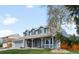 Inviting exterior view of a two-story home with a covered front porch and landscaped yard at 12945 E Colorado Ave, Aurora, CO 80012