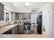 Well-lit kitchen with grey cabinets, stainless steel appliances, and an eat-in area at 12945 E Colorado Ave, Aurora, CO 80012