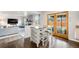 Bright kitchen featuring a breakfast bar, hardwood floors, and direct access to the outdoor space at 12945 E Colorado Ave, Aurora, CO 80012
