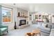 Inviting living room with a fireplace, large windows, and an open layout to the kitchen at 12945 E Colorado Ave, Aurora, CO 80012