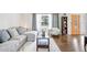 Comfortable living room featuring hardwood floors, a sectional sofa, and lots of natural light at 12945 E Colorado Ave, Aurora, CO 80012