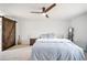 Spacious main bedroom with a ceiling fan and a sliding barn door to the closet at 12945 E Colorado Ave, Aurora, CO 80012