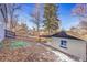 Landscaped backyard with detached garage and storage shed at 1361 W Custer Pl, Denver, CO 80223