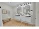 Modern bathroom with double vanity, floating cabinets, and marble shower at 1361 W Custer Pl, Denver, CO 80223