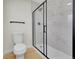Clean bathroom with toilet and large walk-in shower with glass door at 1361 W Custer Pl, Denver, CO 80223