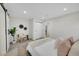 Light and airy bedroom with a cozy sitting area and access to hallway at 1361 W Custer Pl, Denver, CO 80223