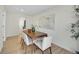 Modern dining room with wood table and chairs, open to kitchen at 1361 W Custer Pl, Denver, CO 80223