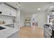 Newly renovated kitchen boasting white cabinets, quartz countertops, and a stylish backsplash at 1361 W Custer Pl, Denver, CO 80223