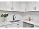 Modern kitchen with white cabinets, quartz countertops, and stainless steel appliances at 1361 W Custer Pl, Denver, CO 80223