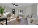 Light-filled living room showcasing stylish furnishings and hardwood floors at 1361 W Custer Pl, Denver, CO 80223