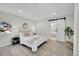 Spacious main bedroom with barn door to bathroom and ample natural light at 1361 W Custer Pl, Denver, CO 80223