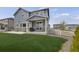 Backyard featuring a covered patio, lawn, and nice sliding glass doors at 6802 S Uriah St, Aurora, CO 80016