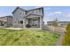 Spacious backyard area with covered patio and sliding glass door, perfect for outdoor living and entertainment at 6802 S Uriah St, Aurora, CO 80016