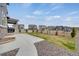 Covered patio with large concrete path leading to fenced in area with low maintenance landscaping at 6802 S Uriah St, Aurora, CO 80016