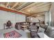 Partially finished basement with seating, exposed ceiling, and potential for customization at 6802 S Uriah St, Aurora, CO 80016