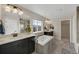 Spacious bathroom with double vanity, soaking tub, dark cabinets, and great natural light at 6802 S Uriah St, Aurora, CO 80016