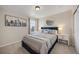 Well-lit bedroom with a skyline picture on the wall and a stylish round mirror at 6802 S Uriah St, Aurora, CO 80016
