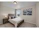 Light-filled bedroom featuring stylish wall art and a window overlooking the neighborhood at 6802 S Uriah St, Aurora, CO 80016