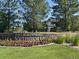Stone sign reading 'The Lakehouse at Southshore' with flowerbeds and mature trees, inviting residents and guests to a beautiful community at 6802 S Uriah St, Aurora, CO 80016