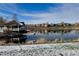Charming community pond view with a gazebo, dock, and reflections of nearby homes at 6802 S Uriah St, Aurora, CO 80016