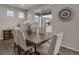 Bright dining room features a wood table, seating for six, and backyard view at 6802 S Uriah St, Aurora, CO 80016