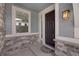 Inviting front entryway with a dark wooden door, stone accents, and a stylish lantern, creating a welcoming atmosphere at 6802 S Uriah St, Aurora, CO 80016